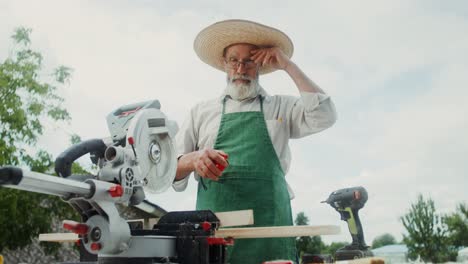 older man working with power tools