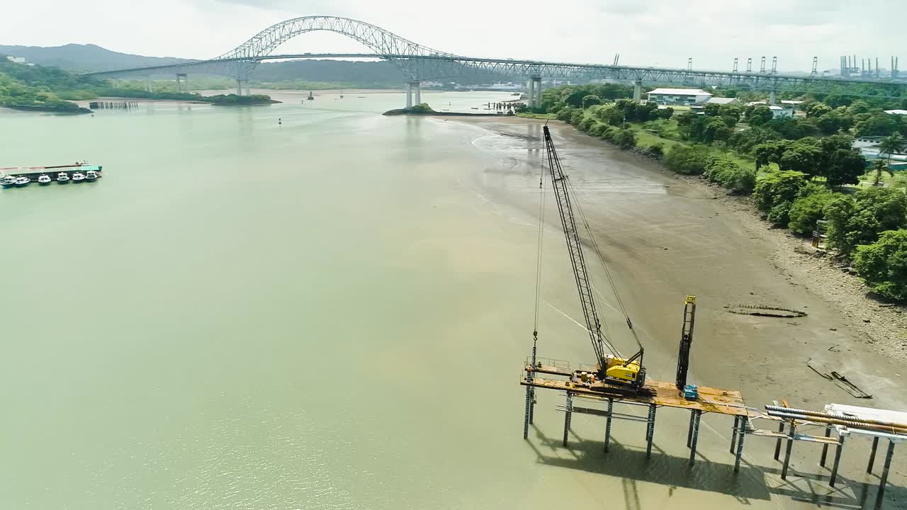 Drone footage of a dock in construction near Panama canal main bridge
