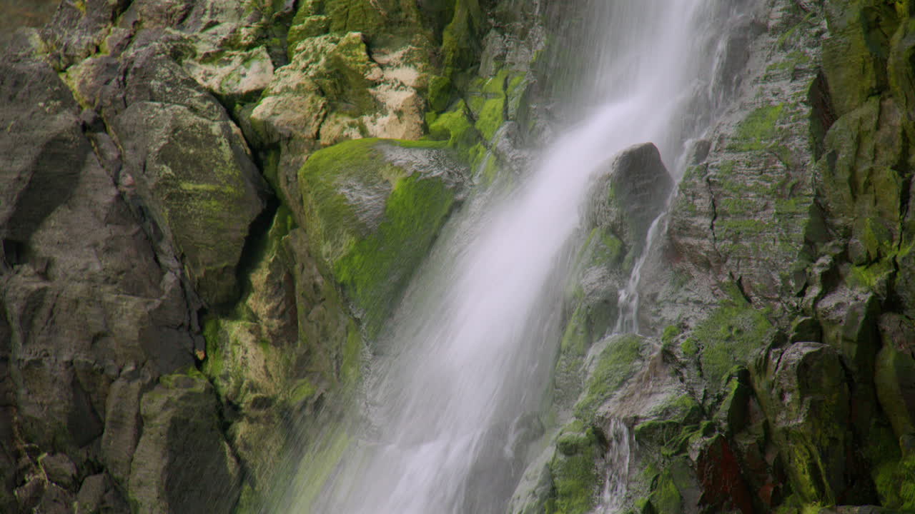 close up shot of Tresaith waterfall landing on rocks