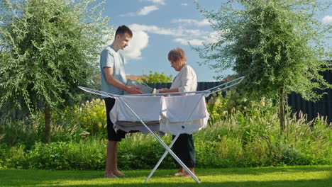 family drying clothes in the garden