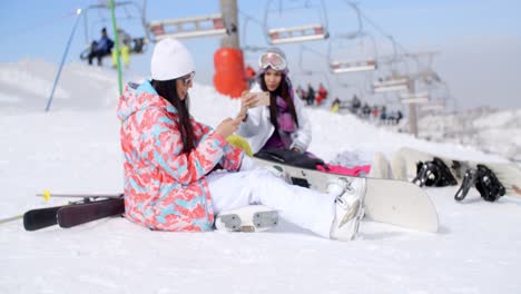 two attractive female snowboarders