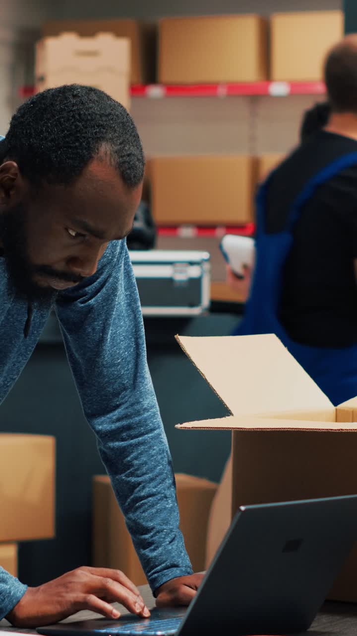 Vertical video: Male entrepreneur analyzing boxes with products to ship order to customers