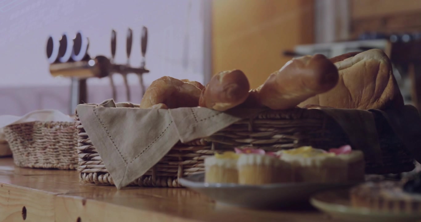 Faint code text appearing, panning view as charts animating over basket and cupcakes showing data