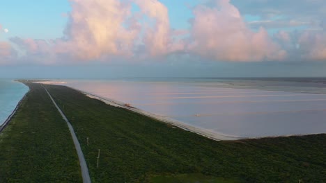 panoramic-aerial-of-famous-pink-lakes-in-Las-Coloradas-Mexico-during-sunset-with-cotton-candy-clouds