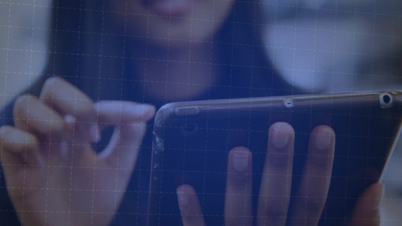 woman tapping tablet at desk causing finance chart growing bars arcing lines appearing candlesticks