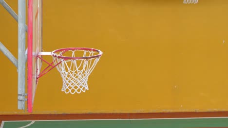basketball ball flies into the basket in the old sports hall.