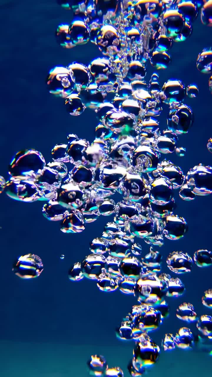 Underwater video captures bubbles rising, shot from below at a low angle, showcasing a serene