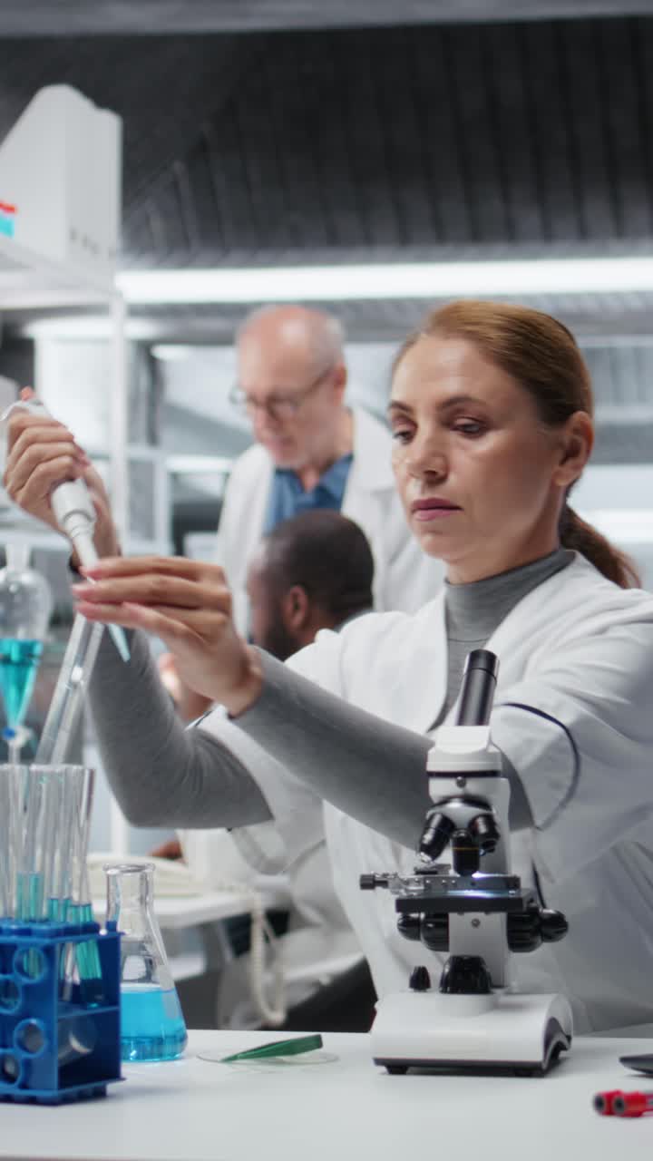 Vertical video Researcher pipetting reactant into blue solution for purity analysis
