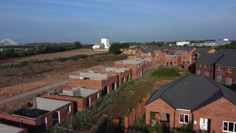 residential housing framework aerial view reversing over unfinished rooftop development on urban building site real estate