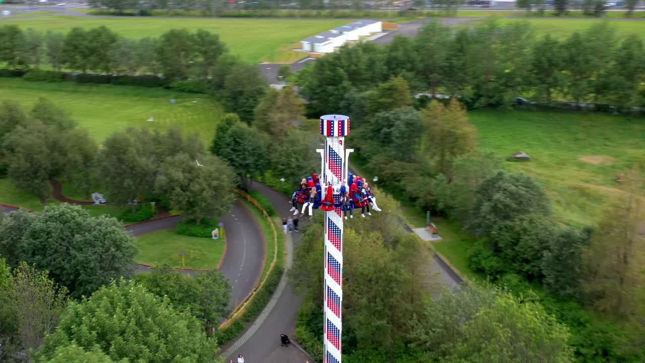 Fun adventure rides at an amusement park and zoo in urban residential neighborhood, Drone shot