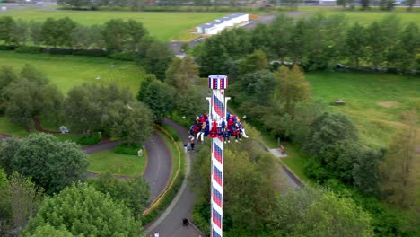 fun adventure rides at an amusement park and zoo in urban residential neighborhood, drone shot