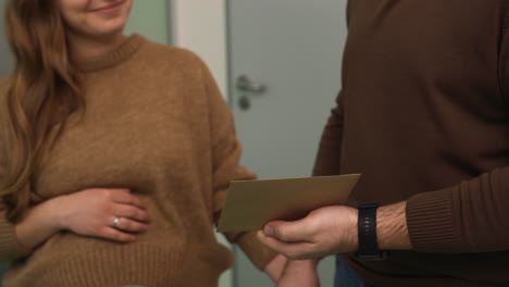 doctor giving envelope to a couple