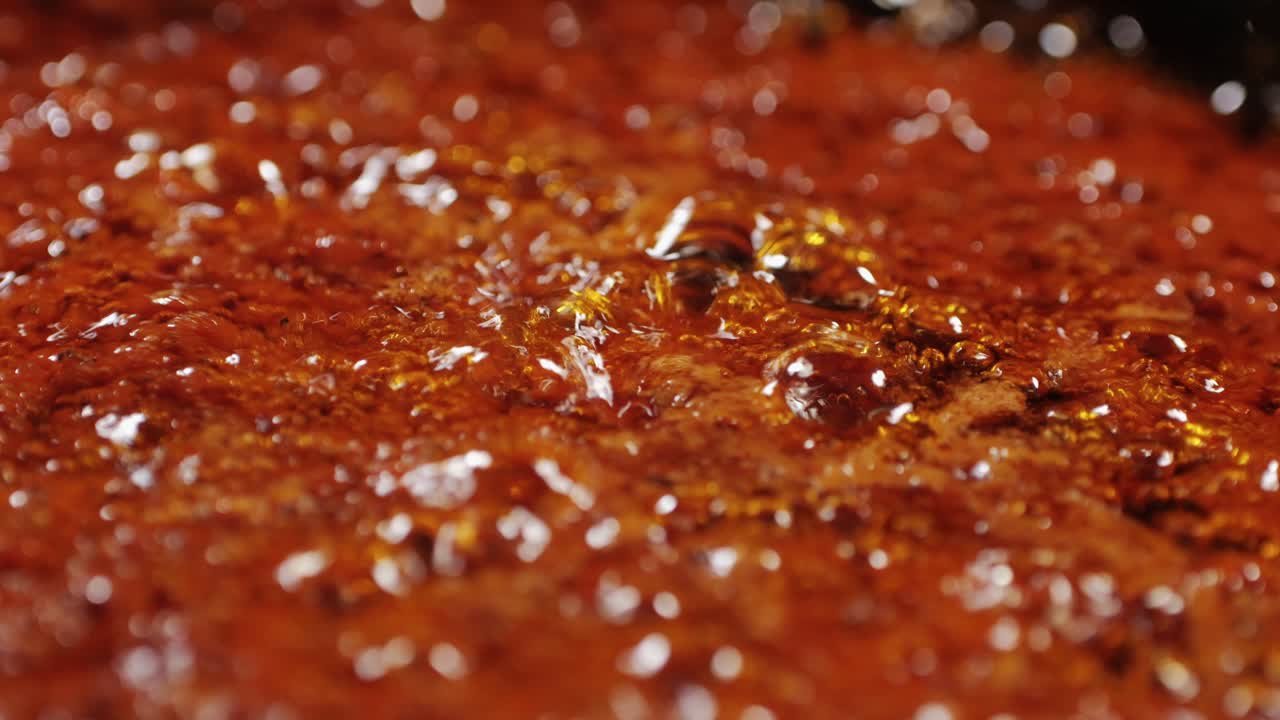Cooking tomato sauce close-up. Classic homemade Italian tomato sauce for pasta and pizza in the pan. Chef cooking traditional Italian food. High quality 4k footage