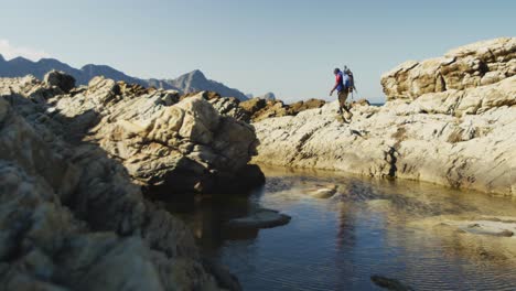 sporty mixed race man with prosthetic leg hiking