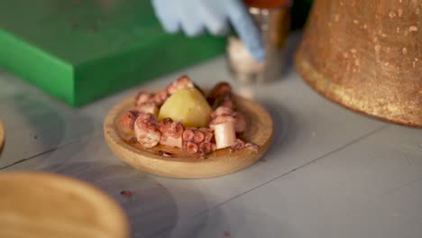 Slow-motion-shot-of-chef-preparing-an-octopus-dish