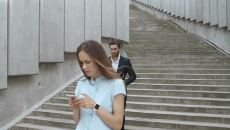 businesswoman waiting for colleague on street. man and woman meeting in city