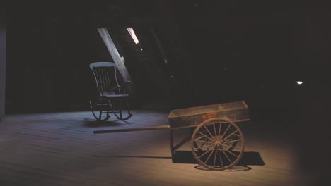 spooky dramatic attic with old rocking chair and wagon