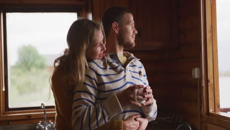 Caucasian-couple-spending-time-at-home-together,-looking-at-the-window