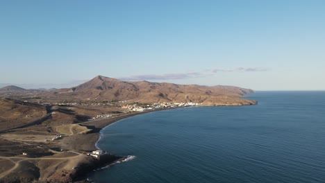 aerial-drone-video-of-a-small-village-on-the-coast-side-of-the-island-Fuerteventura-while-sunset