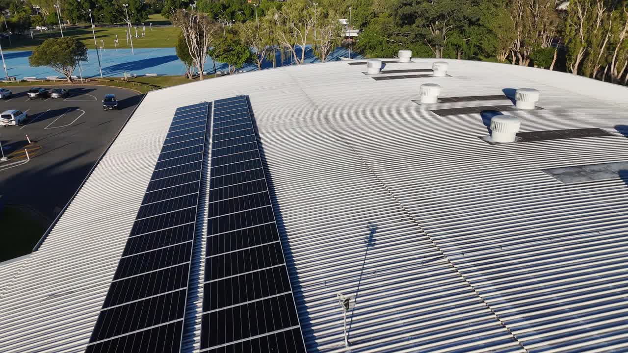 Aerial footage of a rooftop with solar panels and ventilation systems in Gold Coast, Australia, under clear daylight