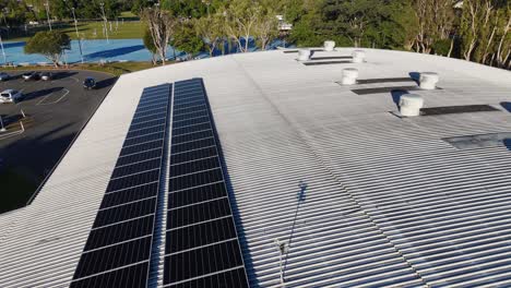 aerial footage of a rooftop with solar panels and ventilation systems in gold coast, australia, under clear daylight