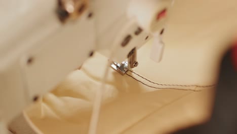 closeup of sewing machine working part with leather. cnc sewing machine