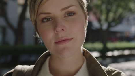 close up portrait of beautiful friendly blonde womanlooking at camera running hand through hair