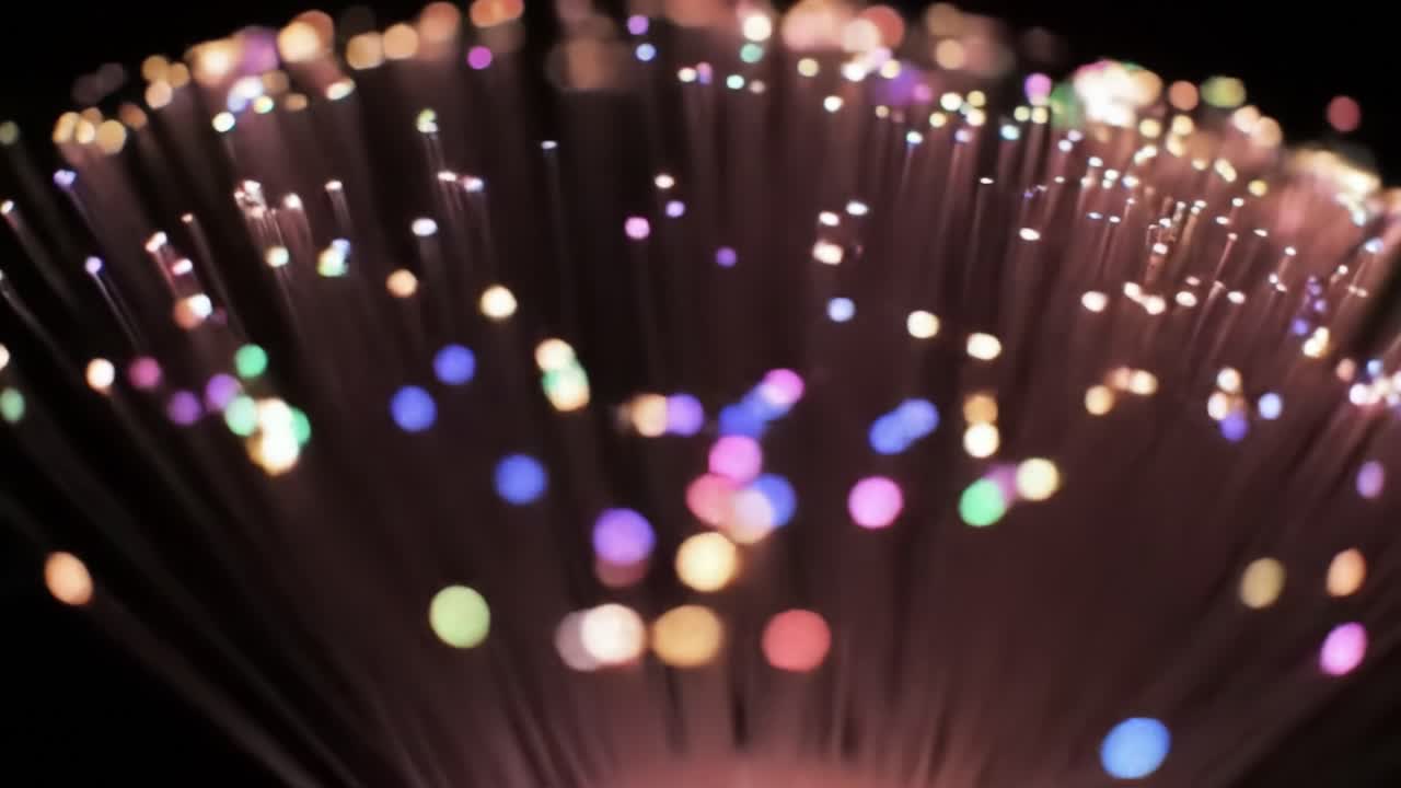 A mesmerizing pattern of colorful lights emerges in a dark environment, creating a stunning visual experience that captivates the viewer through vibrant hues and sparkling effects.