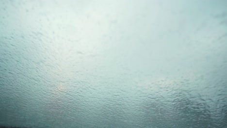 water spraying through window during the storm ciara in the uk - close up shot