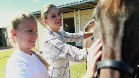 mother and daughter touching the horse 4k