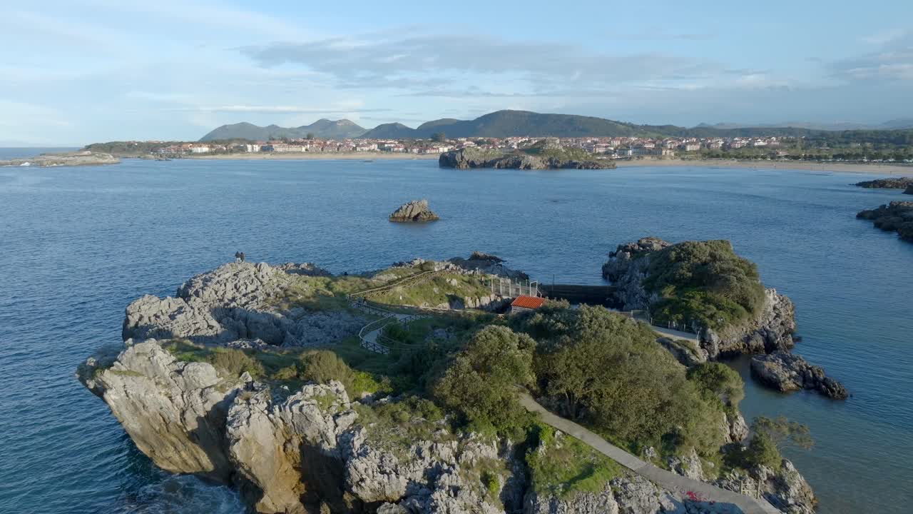 Aerial Orbitign shot of Small peninsula by Cape Quejo with Small house and Natural pool, Cantabrian Coastline
