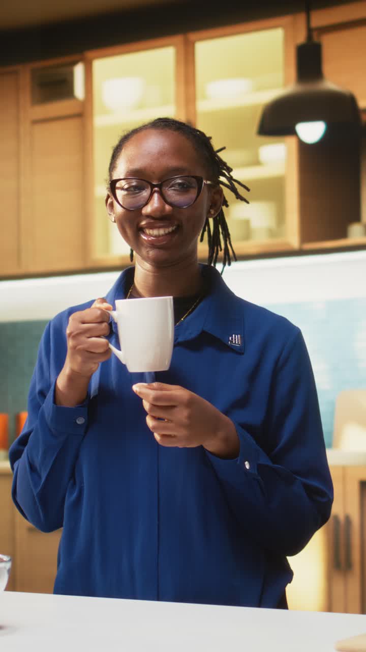 Vertical Video Happy adult in the kitchen smelling the fresh aroma of roasted coffee