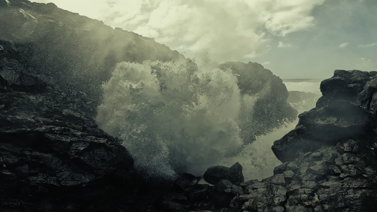 Powerful Ocean Waves Crashing Against Volcanic Rocks