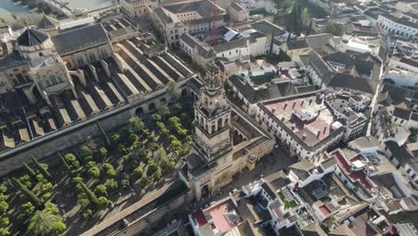 overhead view over islamic mosque and catholic cathedral of cordoba in spain with bell tower. aerial tilt up