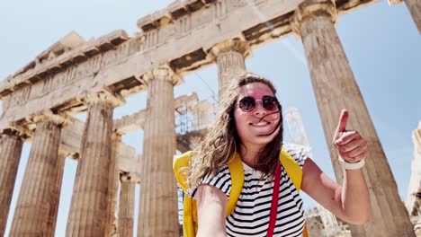 candid woman exploring the acropolis on a windy day, athens, greece