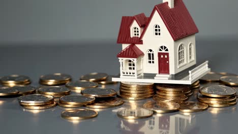 miniature house on stack of coins