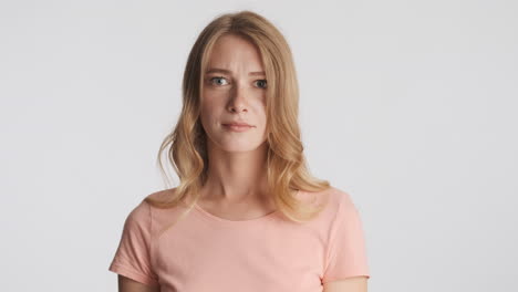 caucasian woman waving no with the head on camera.