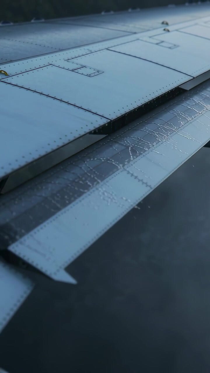 Vertical video: Panning window cam along airplane wing after angle shift to reveal flap track frost