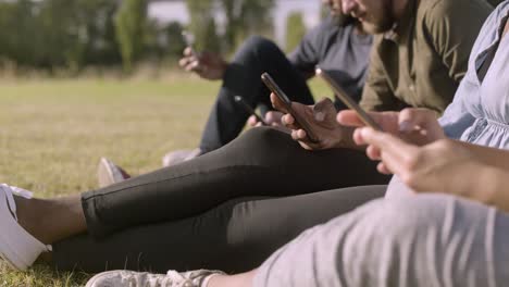 Cropped-shot-of-young-people-using-modern-smartphones.