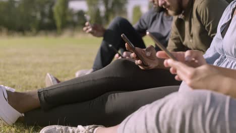 cropped shot of young people using modern smartphones.