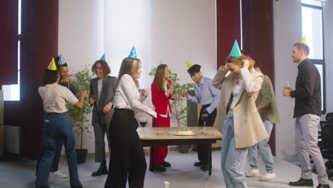 group of multiethnic colleagues dancing and having fun together at the office party 2