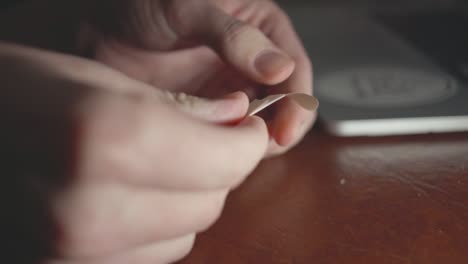 Woman's-Hand-Removing-The-Plastic-Tapes-Of-The-Bandage---Closeup-Shot