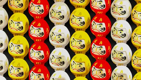 3 colors daruma dolls on black background. loop able animation for background.