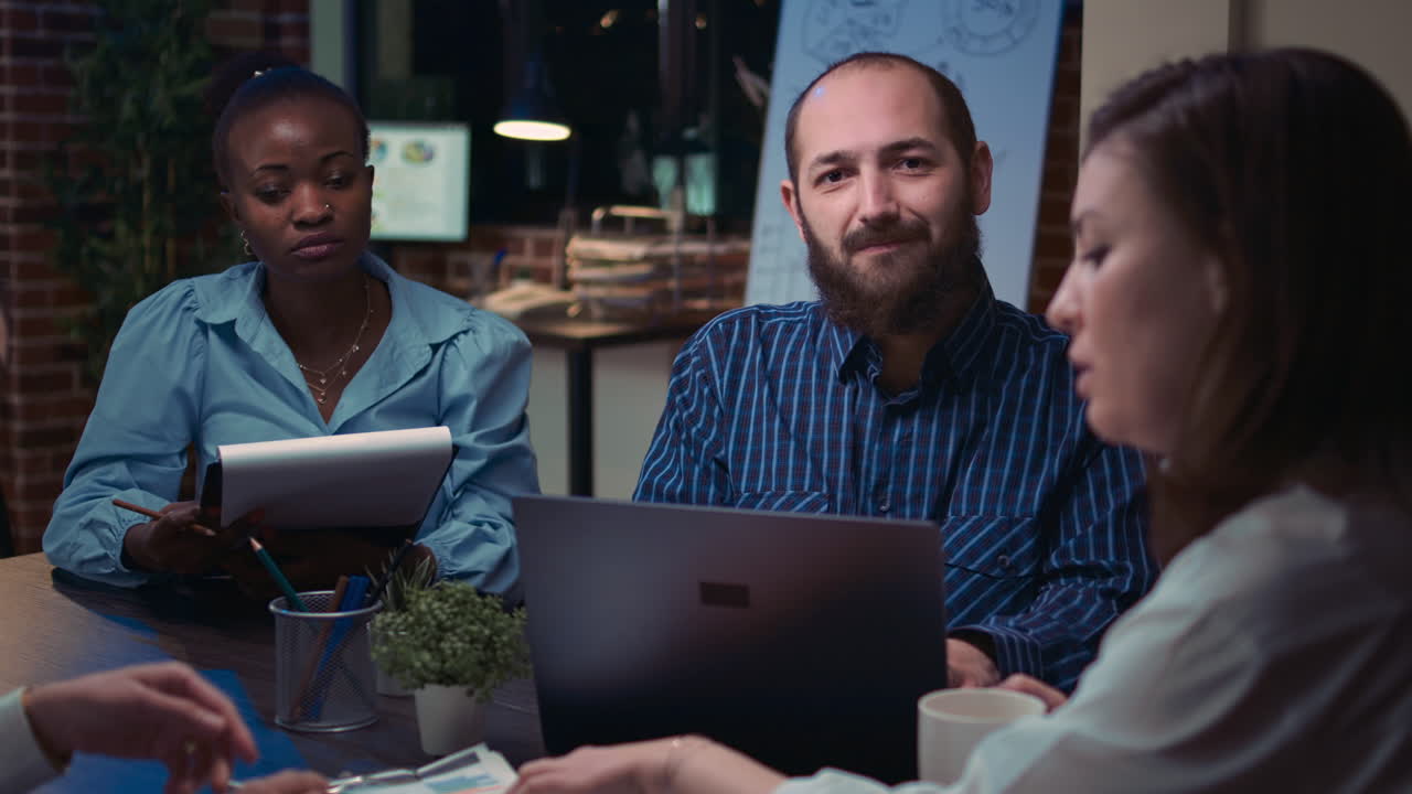 Employees coworking at boardroom table in business meeting