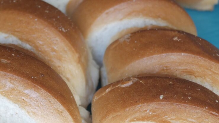 Sliced brioche bread for making torrijas, warm and inviting kitchen scene
