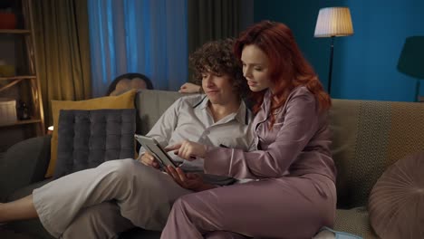 couple watching something on tablet at night