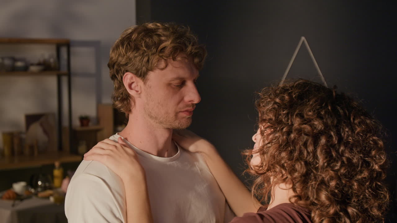 A couple embracing indoors