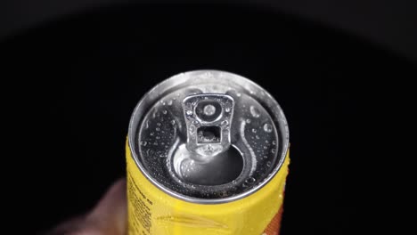 a can of lemonade is being opened