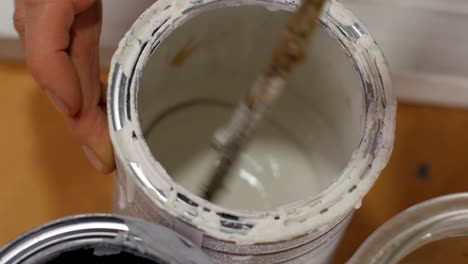 mixing colors with a stirring stick