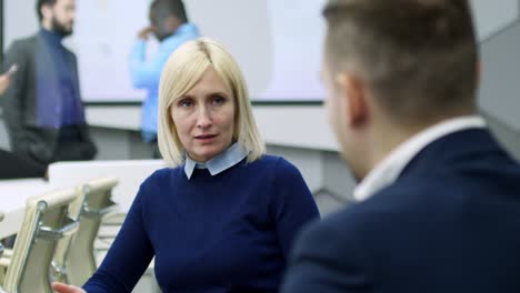 smart businesswoman explaining something to male colleague